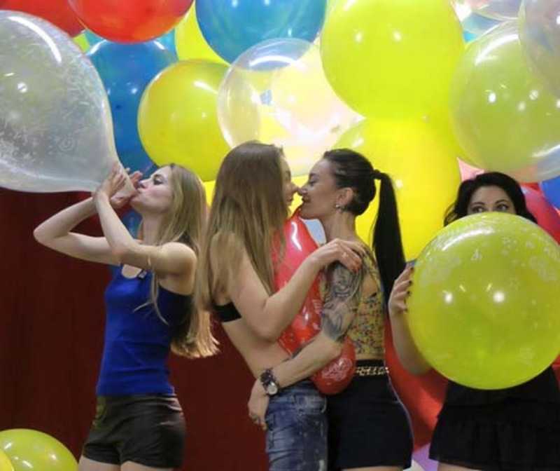 Girls Blowing Balloons
